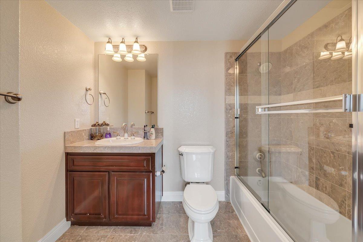 78 Aphrodite Court Copperopolis, CA 95228 - Photo 56 of 98 a bathroom with a sink toilet a mirror and shower