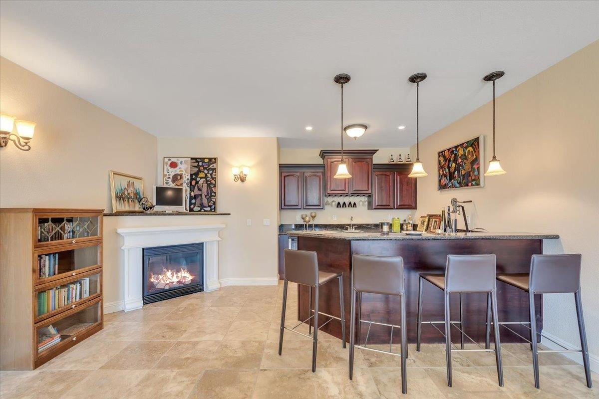 78 Aphrodite Court Copperopolis, CA 95228 - Photo 63 of 98 Down the hall, a dream game room awaits with a cozy fireplace and custom bar!