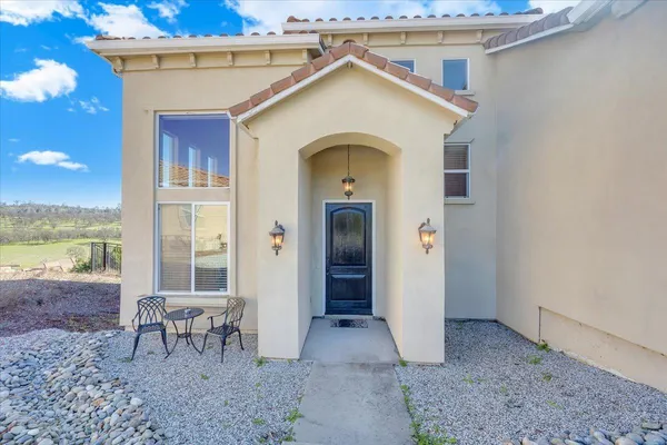 a living room with furniture a large window and a flat screen tv