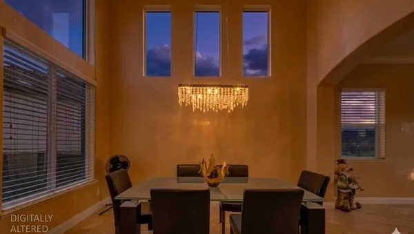 a living room with furniture a flat screen tv and a floor to ceiling window