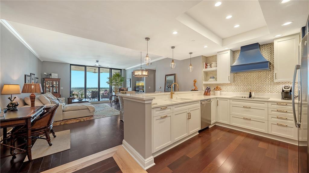 50 Central Avenue, Unit 14B Sarasota, FL 34236 - Photo 11 of 69 a kitchen with stainless steel appliances sink cabinets and wooden floor