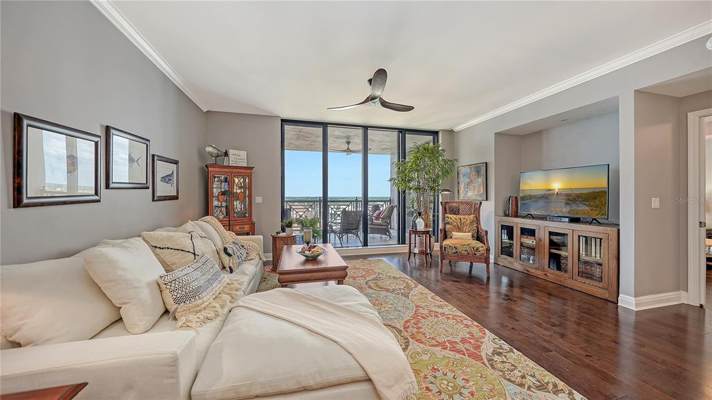 50 Central Avenue, Unit 14B Sarasota, FL 34236 - Photo 20 of 69 a living room with furniture a flat screen tv and a large window