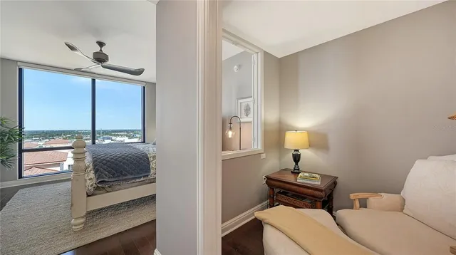 a bed room with a bed window and a flat tv screen on dresser