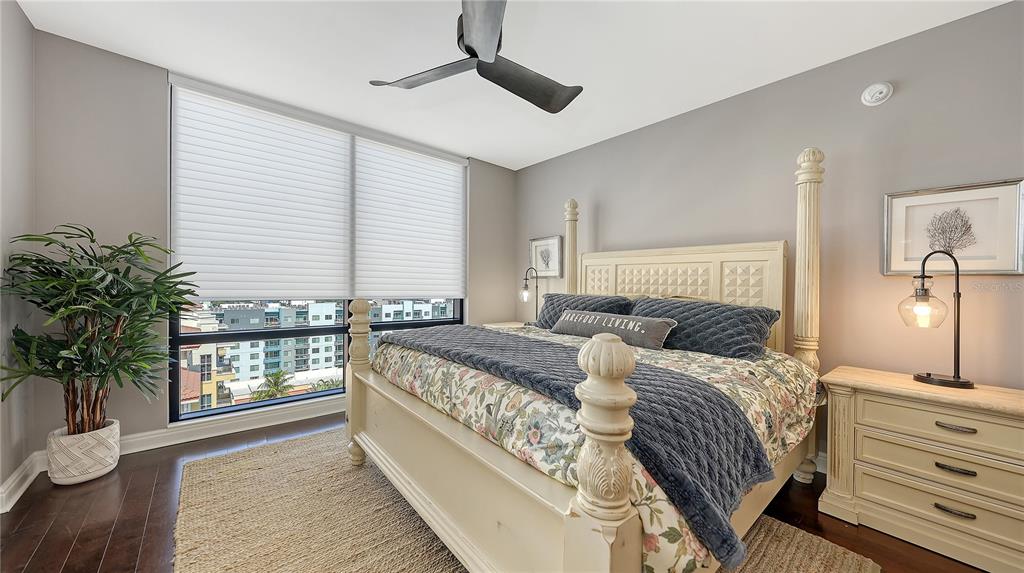 50 Central Avenue, Unit 14B Sarasota, FL 34236 - Photo 28 of 69 a bedroom with a large bed and a potted plant