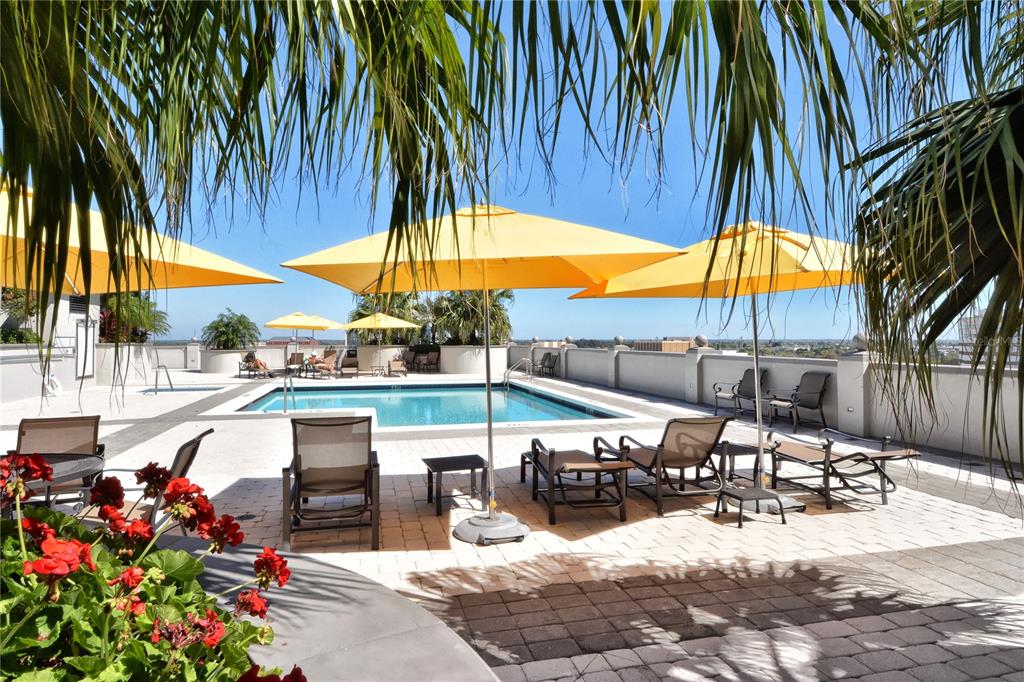 50 Central Avenue, Unit 14B Sarasota, FL 34236 - Photo 3 of 69 an outdoor space with seating area and umbrella