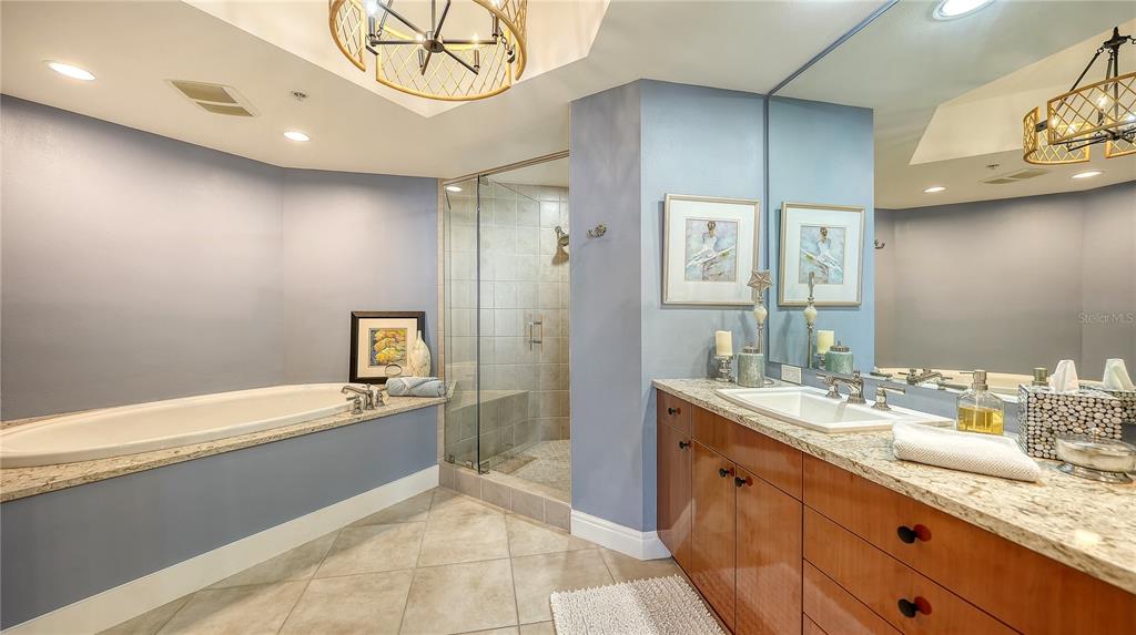 50 Central Avenue, Unit 14B Sarasota, FL 34236 - Photo 33 of 69 a spacious bathroom with a granite countertop sink a toilet a mirror and bathtub