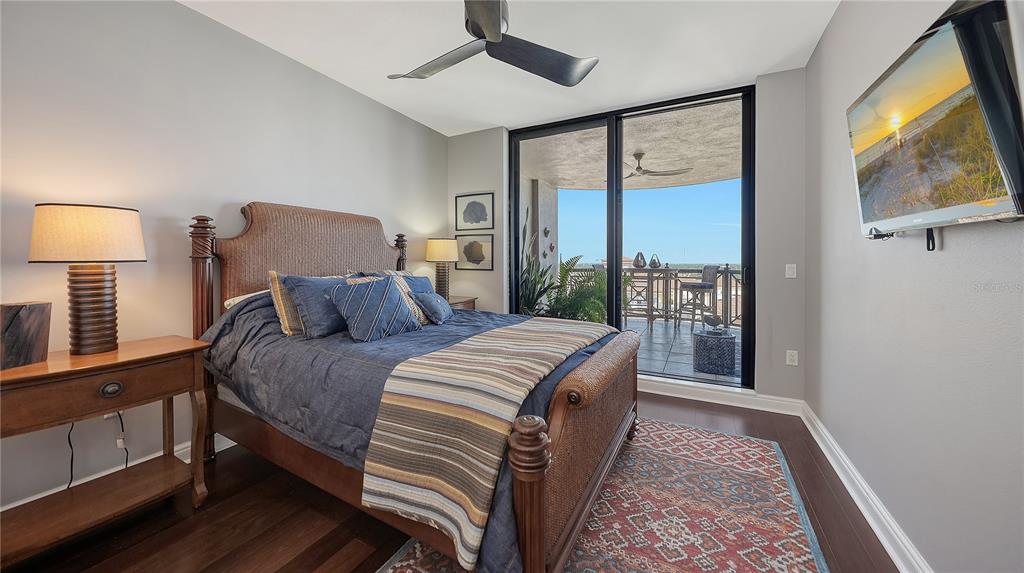 50 Central Avenue, Unit 14B Sarasota, FL 34236 - Photo 34 of 69 a bed room with a bed window and a flat tv screen on dresser