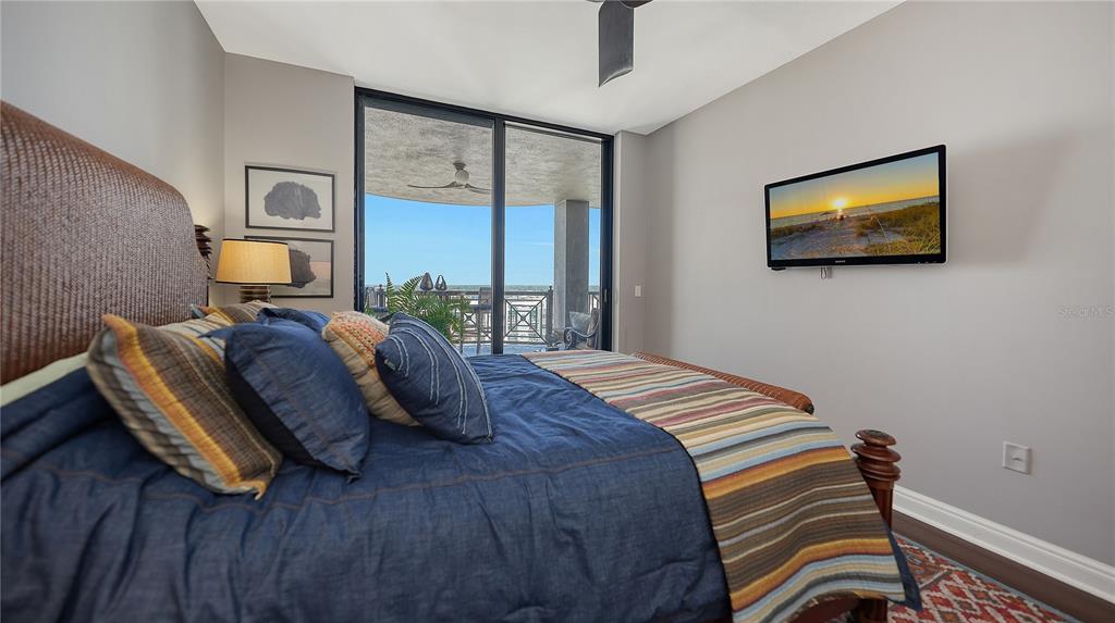 50 Central Avenue, Unit 14B Sarasota, FL 34236 - Photo 35 of 69 a bedroom with bed and a flat tv screen on dresser