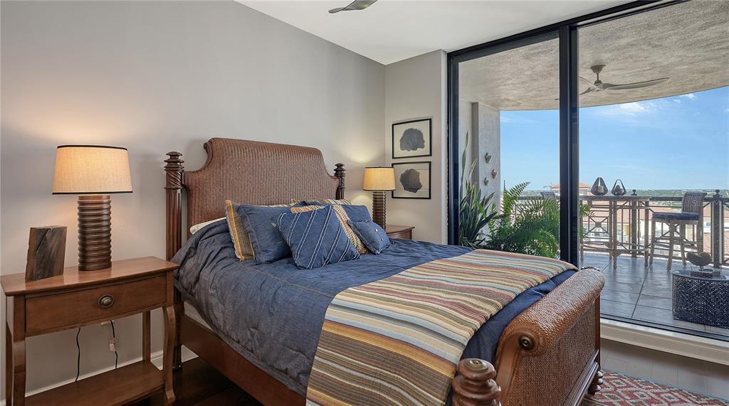 50 Central Avenue, Unit 14B Sarasota, FL 34236 - Photo 36 of 69 a bedroom with a large bed and a lamp next to a window