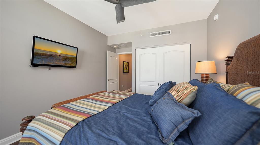 50 Central Avenue, Unit 14B Sarasota, FL 34236 - Photo 38 of 69 a bedroom with a bed and wall painting