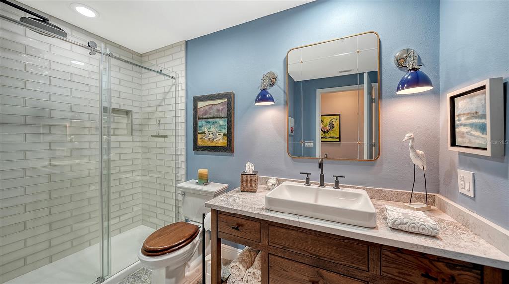 50 Central Avenue, Unit 14B Sarasota, FL 34236 - Photo 39 of 69 a bathroom with a granite countertop toilet sink and mirror