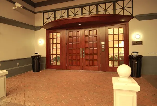 a living room with furniture a fireplace and a chandelier