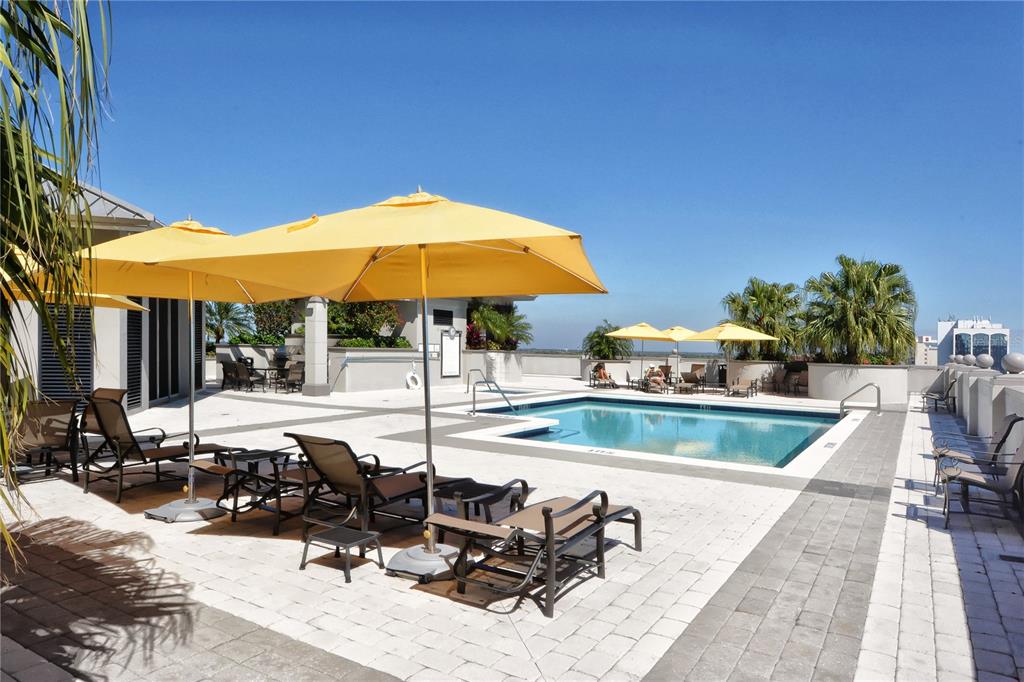 50 Central Avenue, Unit 14B Sarasota, FL 34236 - Photo 53 of 69 a view of a patio with a table and chairs under an umbrella