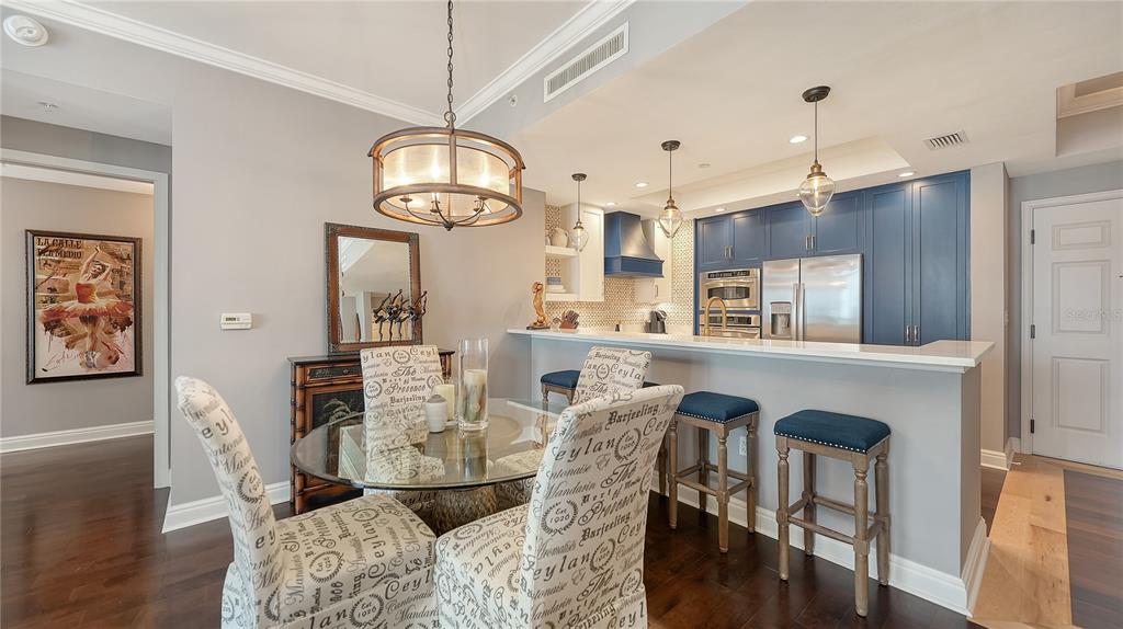 50 Central Avenue, Unit 14B Sarasota, FL 34236 - Photo 7 of 69 a view of a dining room with furniture and wooden floor