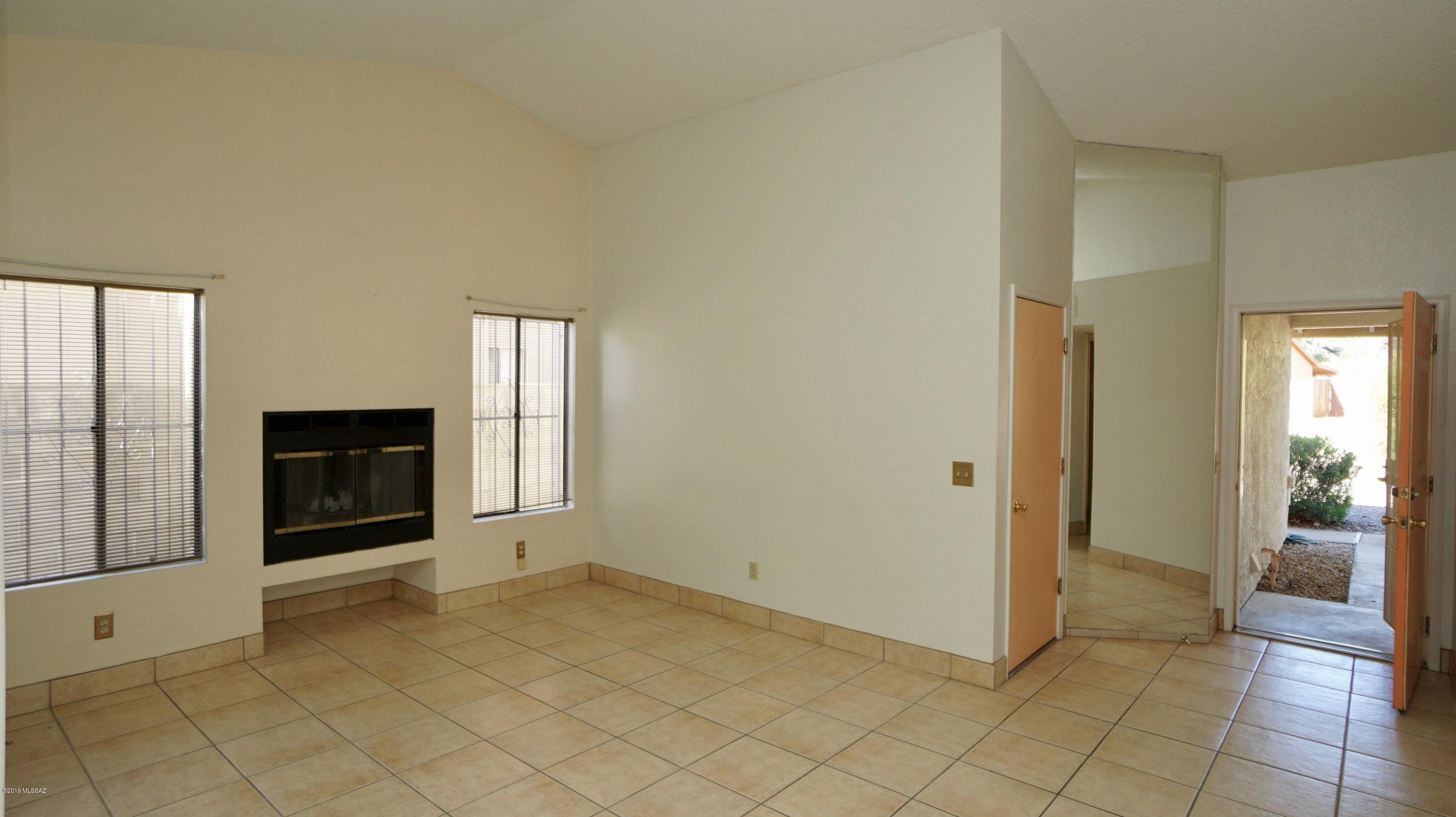 4796 South Lincoln Ridge Drive Tucson, AZ 85730 - Photo 3 of 12 a view of a livingroom with a fireplace