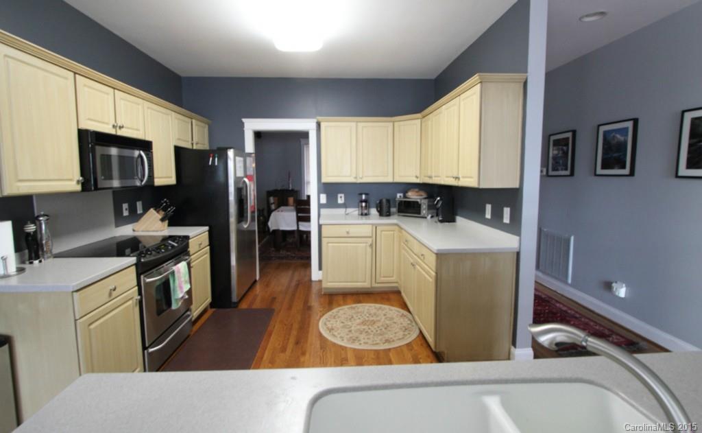 112 View Lake Street Davidson, NC 28036 - Photo 8 of 24 a kitchen with a sink a counter top space a refrigerator and cabinets
