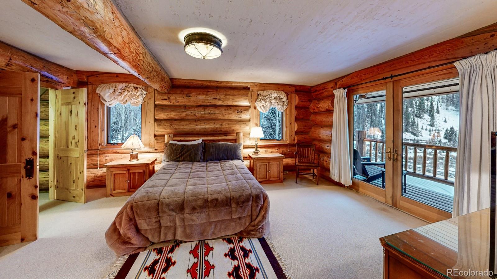 2418 Forest Road Creede, CO 81130 - Photo 14 of 50 a bedroom with furniture and a fireplace