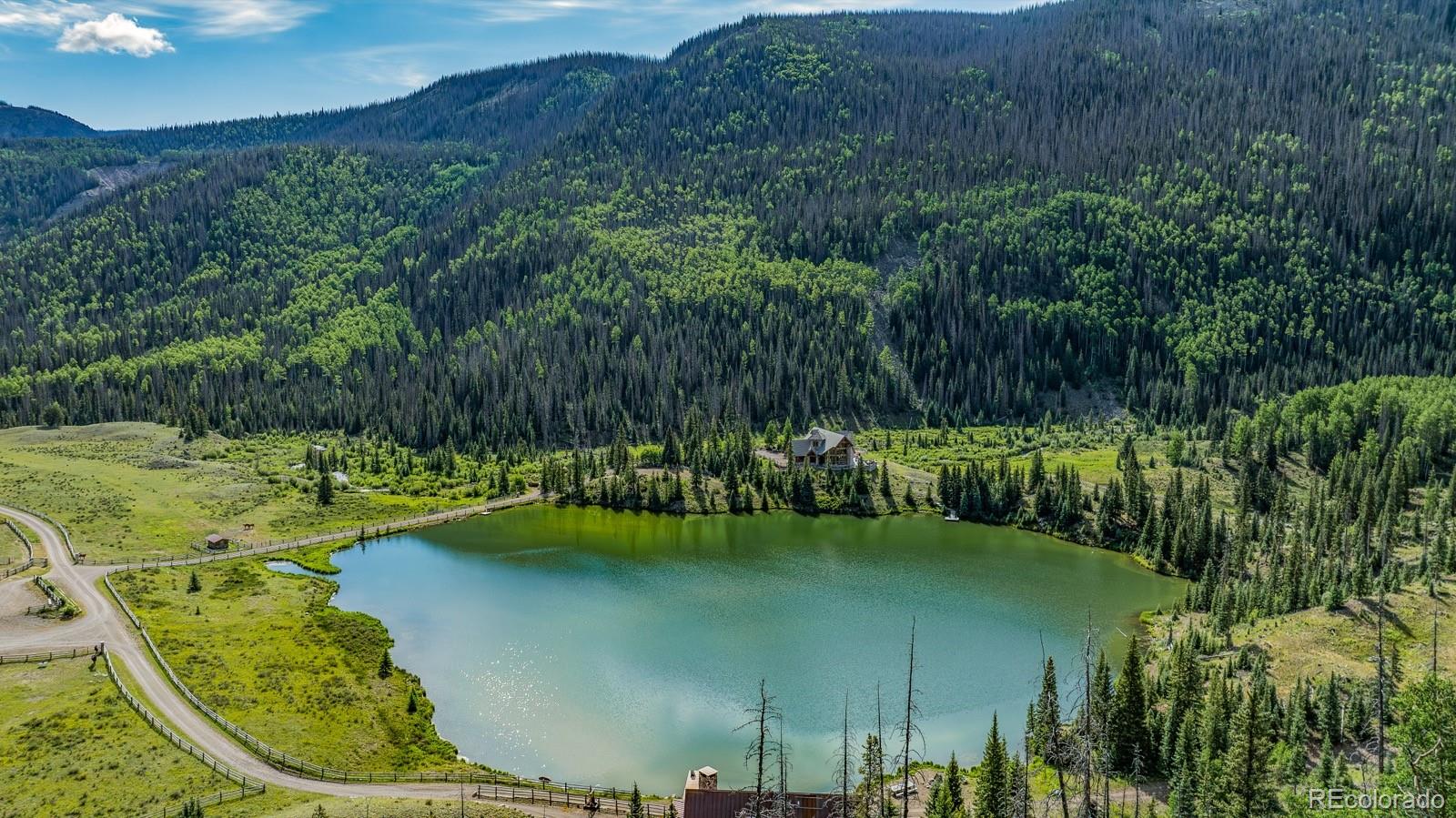 2418 Forest Road Creede, CO 81130 - Photo 24 of 50 a view of a lake with a yard