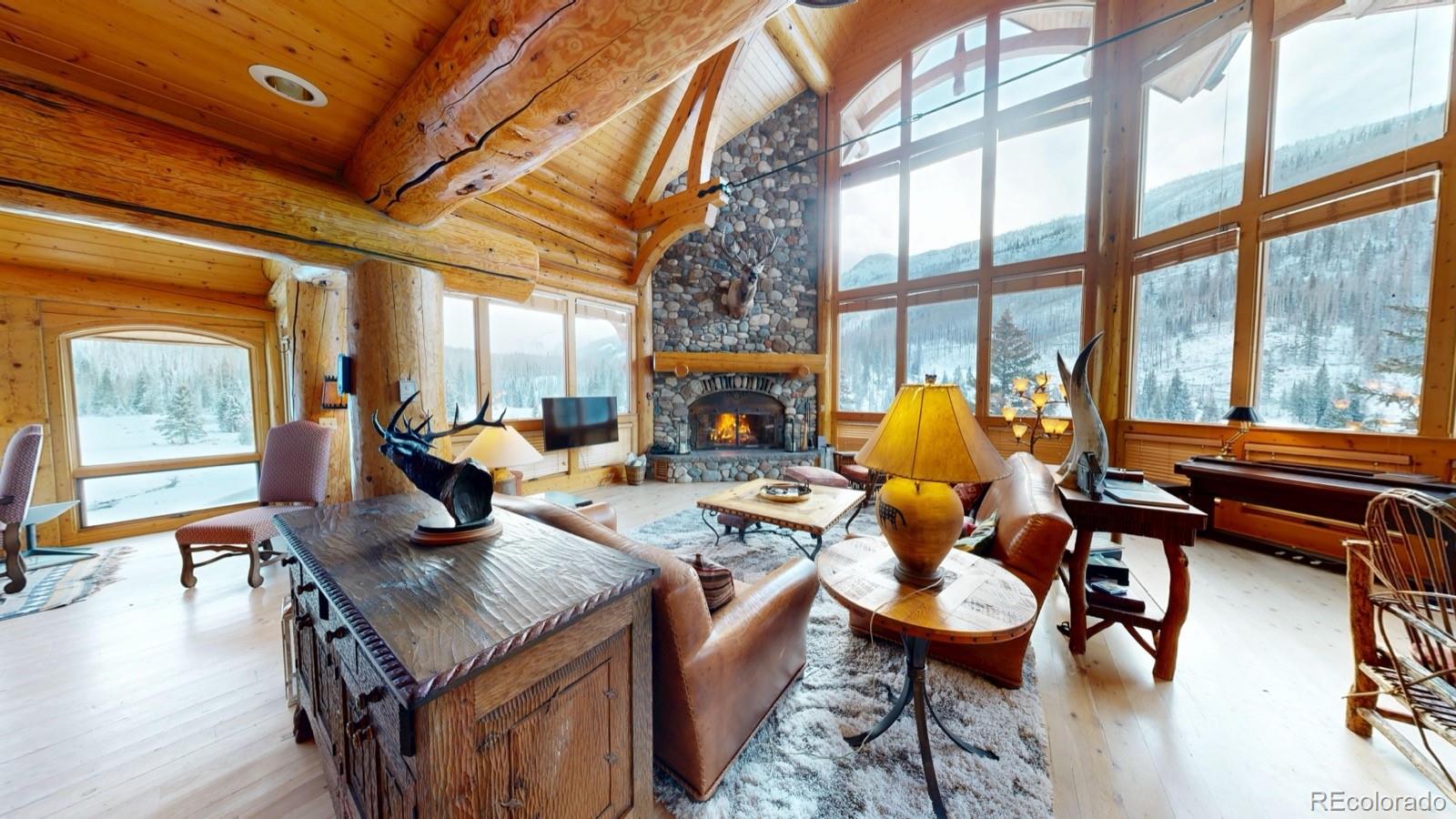 2418 Forest Road Creede, CO 81130 - Photo 5 of 50 a living room with fireplace furniture and a large window