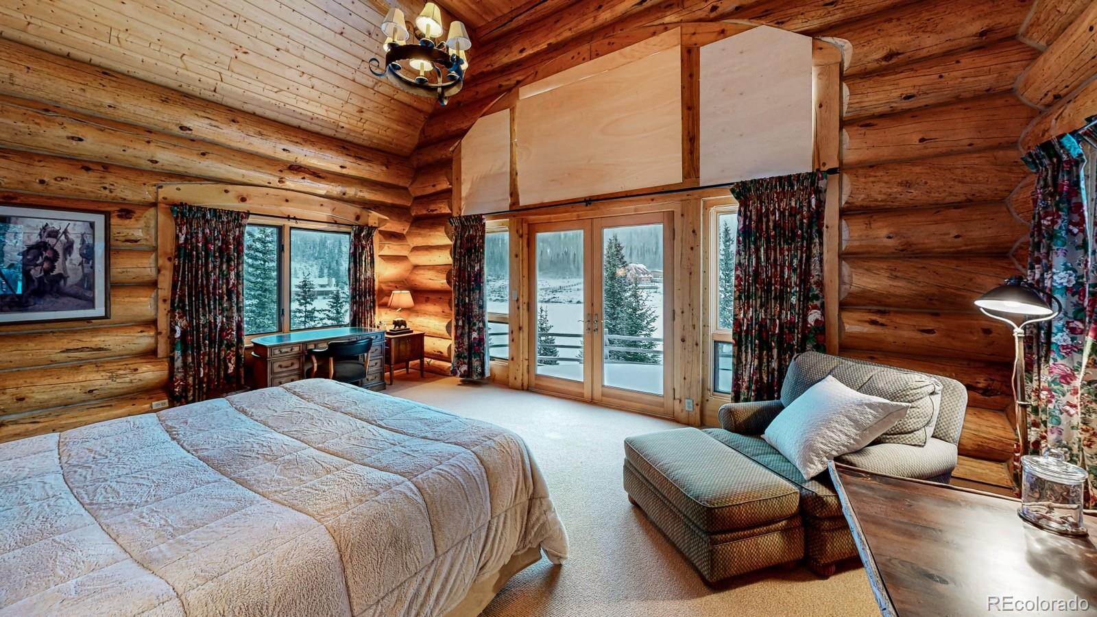 2418 Forest Road Creede, CO 81130 - Photo 7 of 50 a bedroom with furniture and large windows