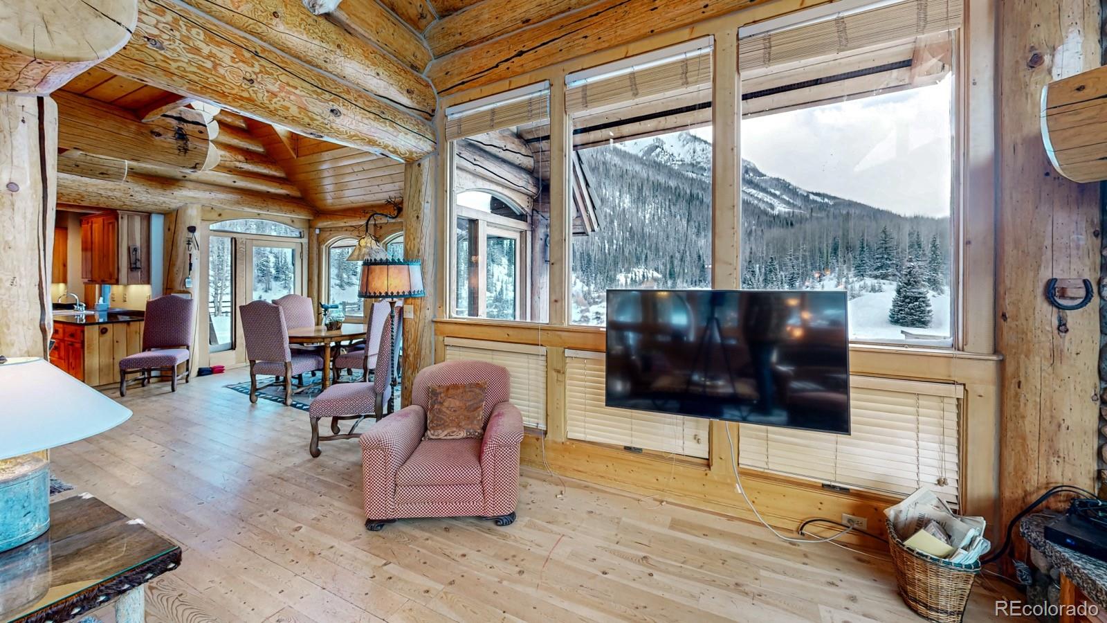 2418 Forest Road Creede, CO 81130 - Photo 10 of 50 a living room with furniture a flat screen tv and a floor to ceiling window