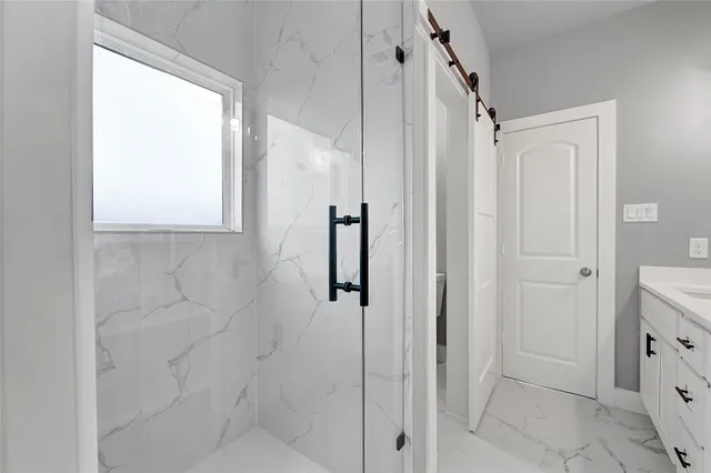 a bathroom with a shower and a sink