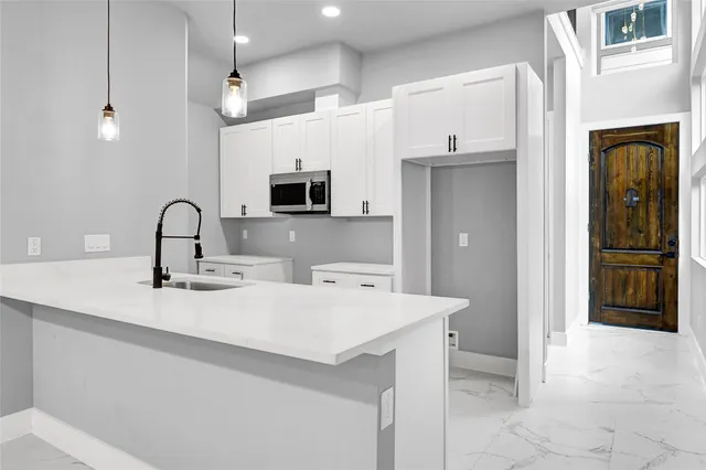 a kitchen with stainless steel appliances a sink stove and refrigerator