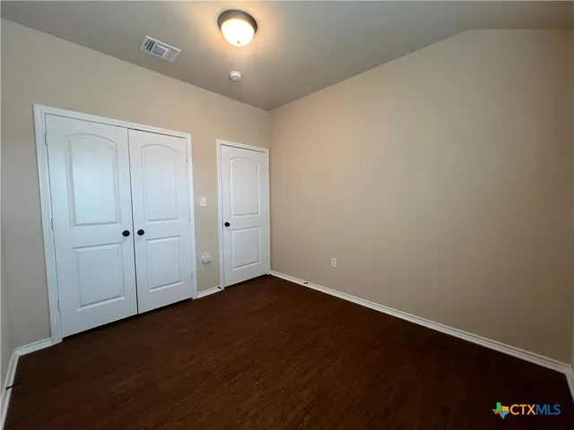 an empty room with wooden floor