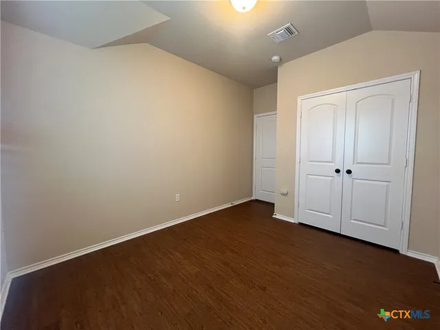 an empty room with wooden floor