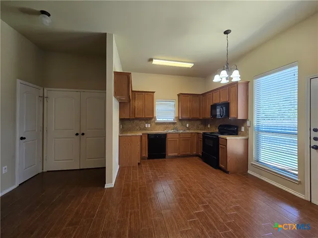 a kitchen with kitchen island a sink stainless steel appliances and cabinets