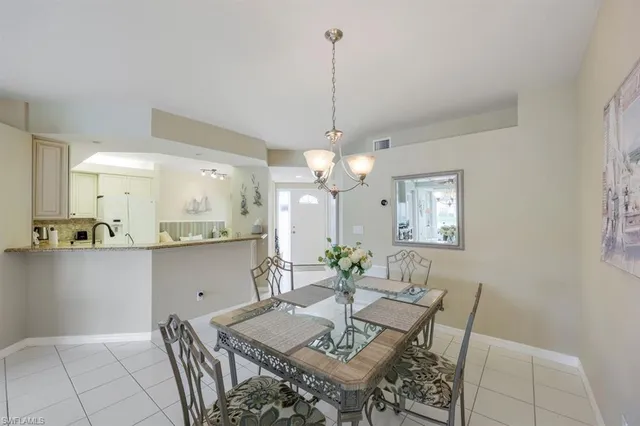 a view of a dining room with furniture and chandelier