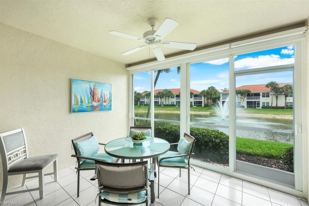23730 Eddystone Road, Unit 5102 Bonita Springs, FL 34135 - Photo 2 of 24 a view of a dining room with furniture wooden floor and floor to ceiling window