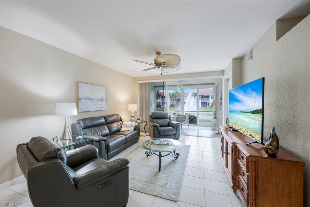 23730 Eddystone Road, Unit 5102 Bonita Springs, FL 34135 - Photo 21 of 24 a living room with furniture and a flat screen tv