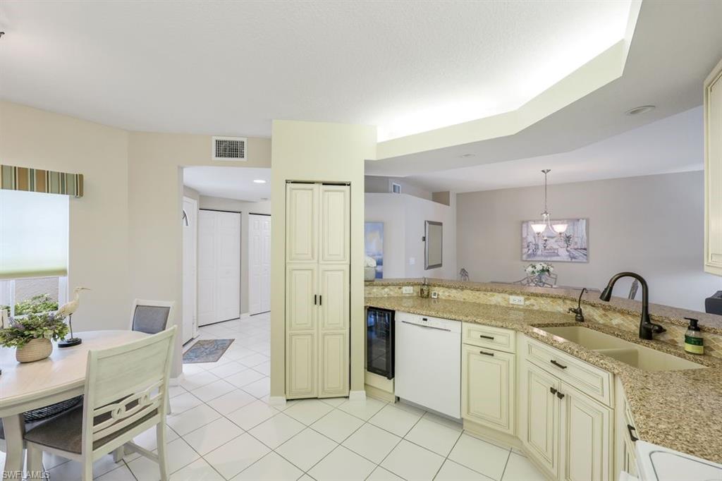 23730 Eddystone Road, Unit 5102 Bonita Springs, FL 34135 - Photo 22 of 24 a spacious bathroom with a granite countertop sink a mirror and a