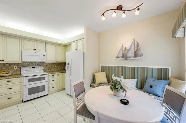 a kitchen with stainless steel appliances kitchen island granite countertop a sink and cabinets