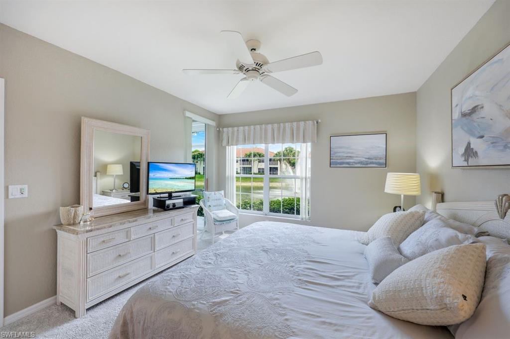 23730 Eddystone Road, Unit 5102 Bonita Springs, FL 34135 - Photo 3 of 24 a large bedroom with a bed and a flat tv screen on dresser