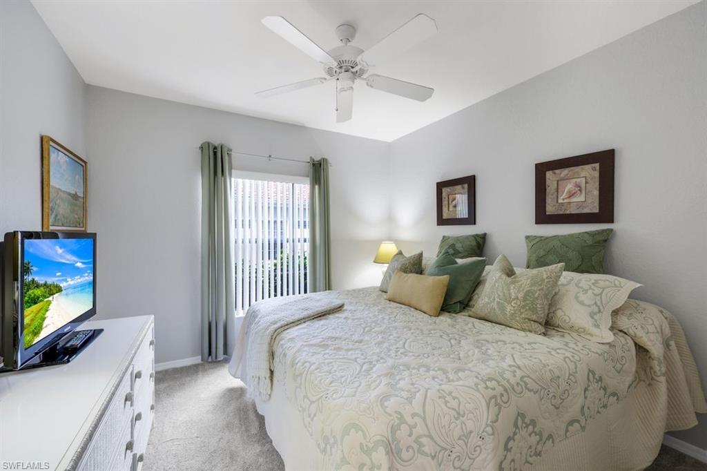 23730 Eddystone Road, Unit 5102 Bonita Springs, FL 34135 - Photo 10 of 24 a bedroom with a bed and a flat screen tv