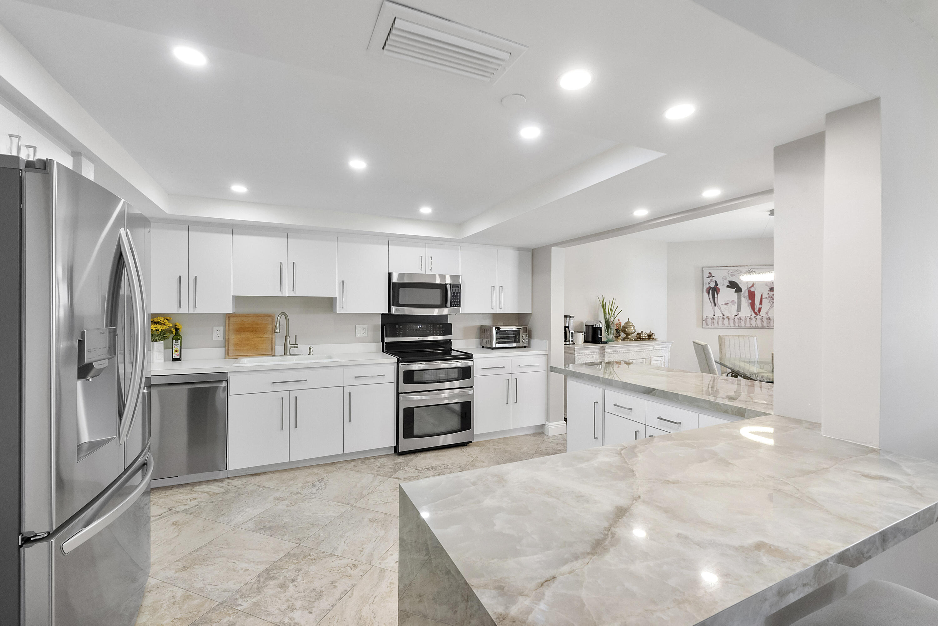 a kitchen with refrigerator and cabinets