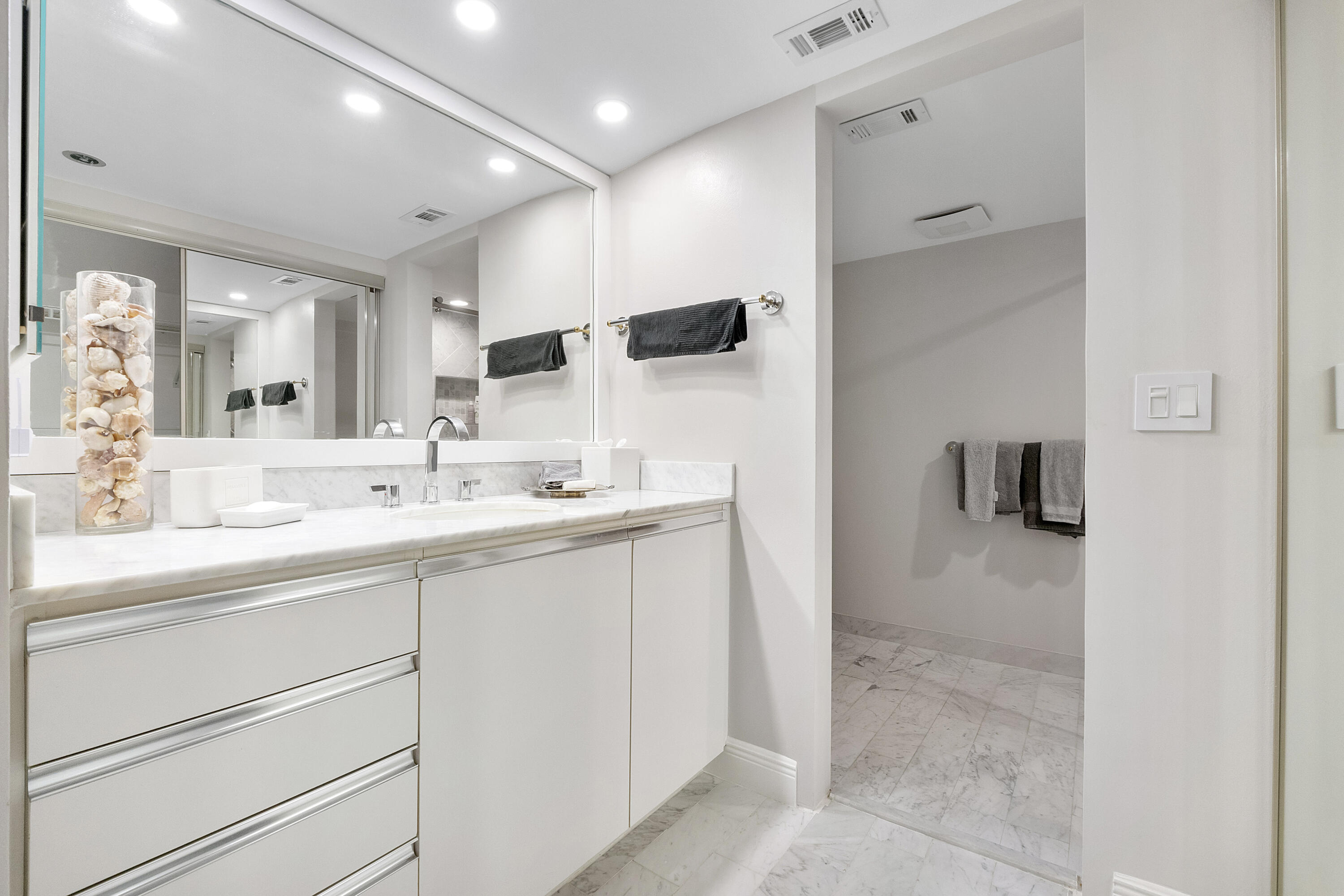 501 North Riverside Drive, Unit 203 Pompano Beach, FL 33062 - Photo 11 of 35 a bathroom with a sink a double vanity and a mirror