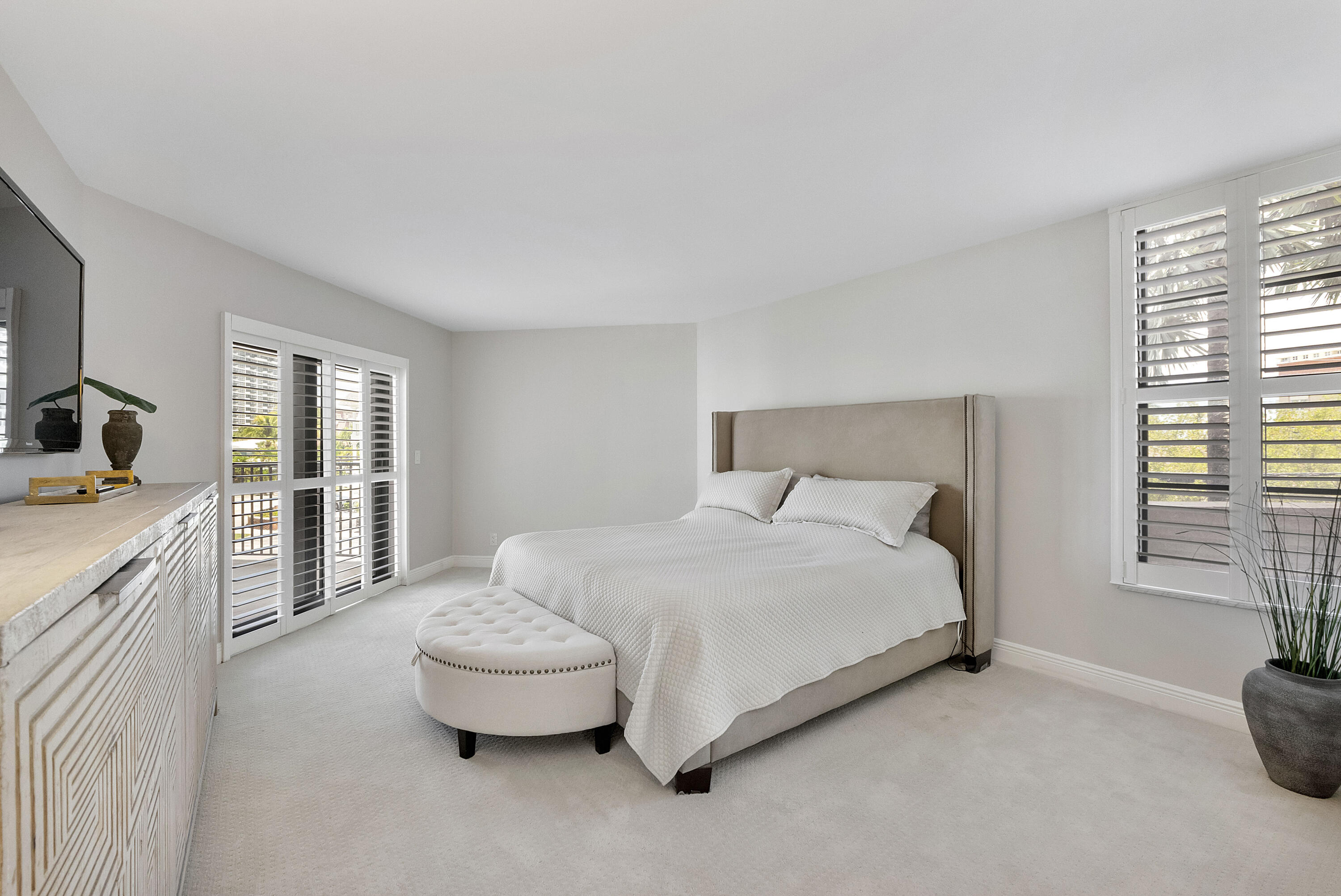 501 North Riverside Drive, Unit 203 Pompano Beach, FL 33062 - Photo 14 of 35 a spacious bedroom with a bed and a cabinets