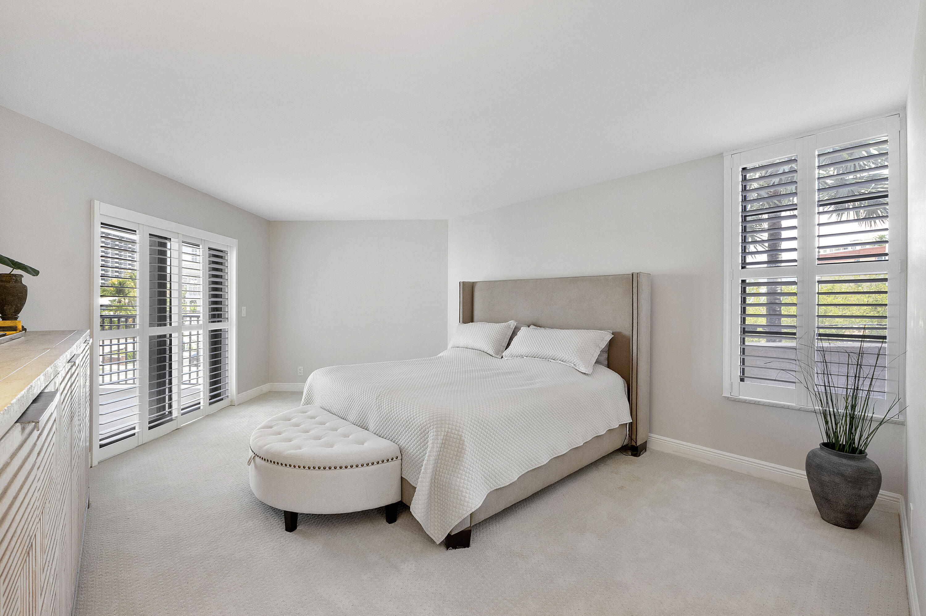 501 North Riverside Drive, Unit 203 Pompano Beach, FL 33062 - Photo 15 of 35 a bedroom with a bed and a couch next to a window