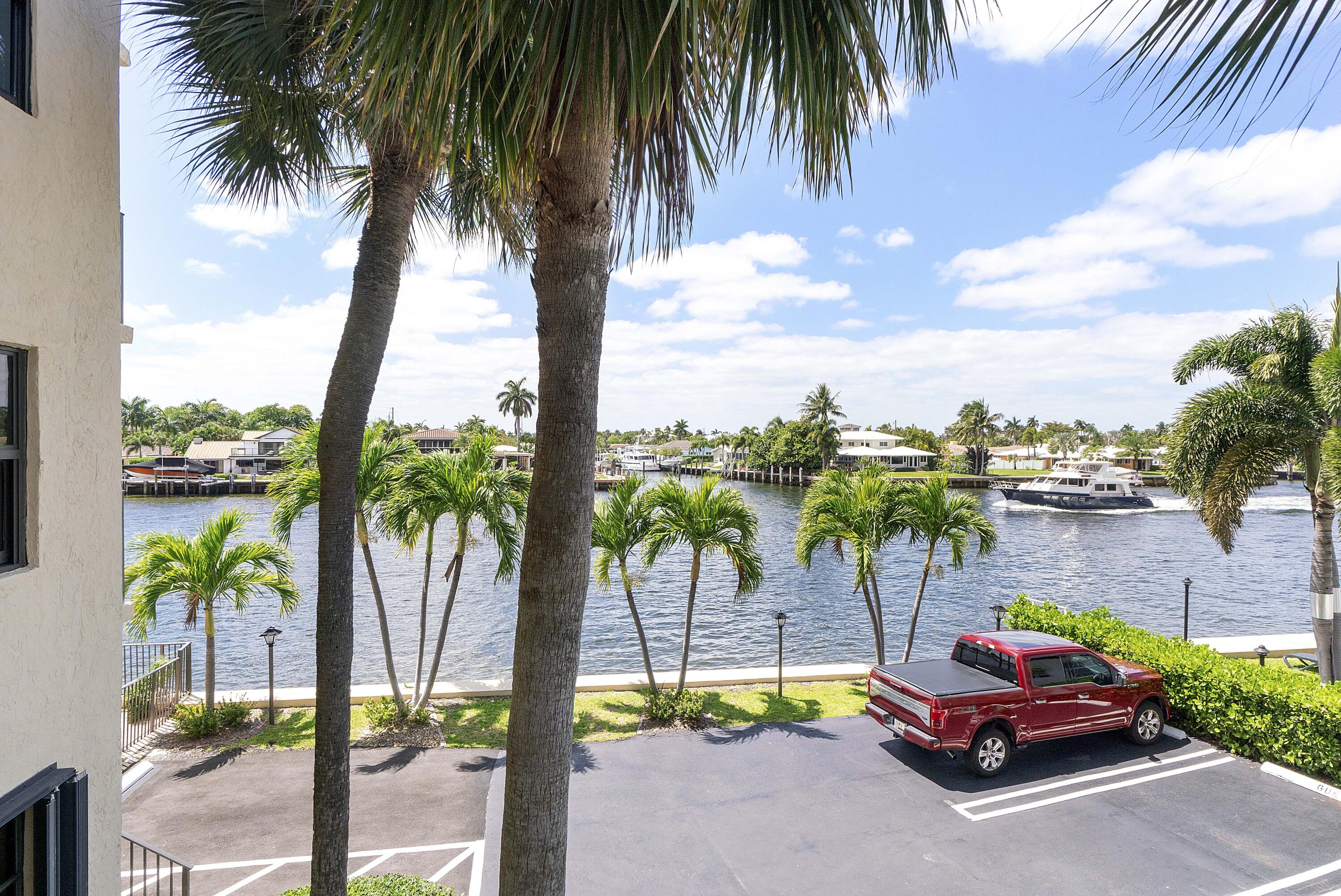 501 North Riverside Drive, Unit 203 Pompano Beach, FL 33062 - Photo 30 of 35 a row of palm trees and swimming pool in the patio