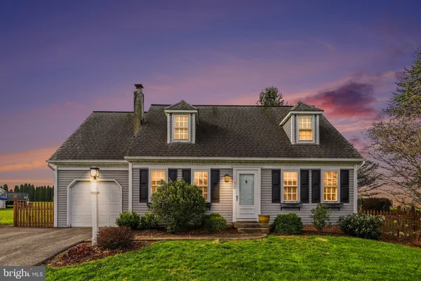 a front view of a house with a yard and a garage