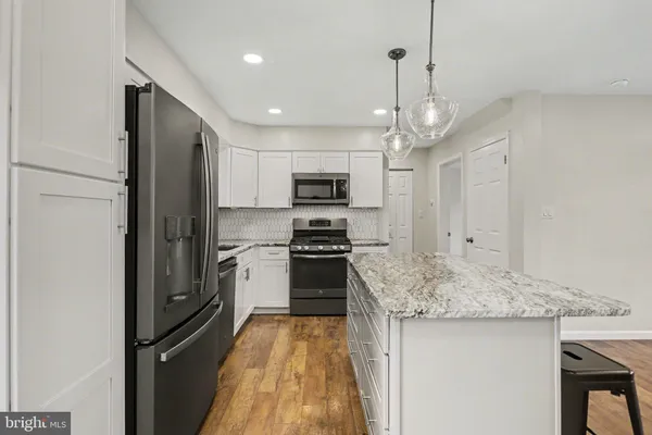 a kitchen with stainless steel appliances granite countertop a stove and a sink