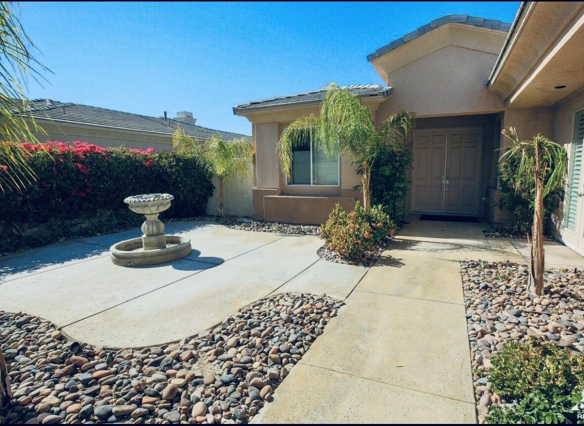 a front view of a house with garden