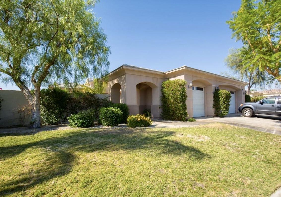 62 Victor Hugo Road Rancho Mirage, CA 92270 - Photo 2 of 14 a front view of a house with a yard garage and outdoor seating