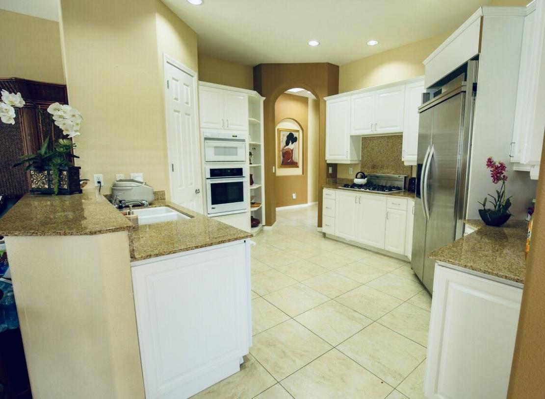 62 Victor Hugo Road Rancho Mirage, CA 92270 - Photo 10 of 14 a kitchen with stainless steel appliances granite countertop a sink and a refrigerator