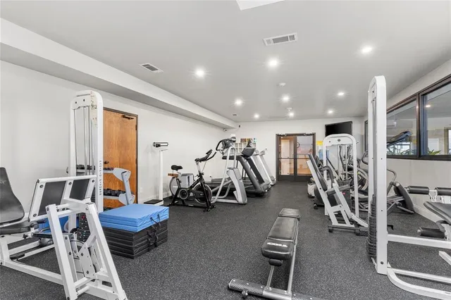 a living room with lots of furniture and a large window