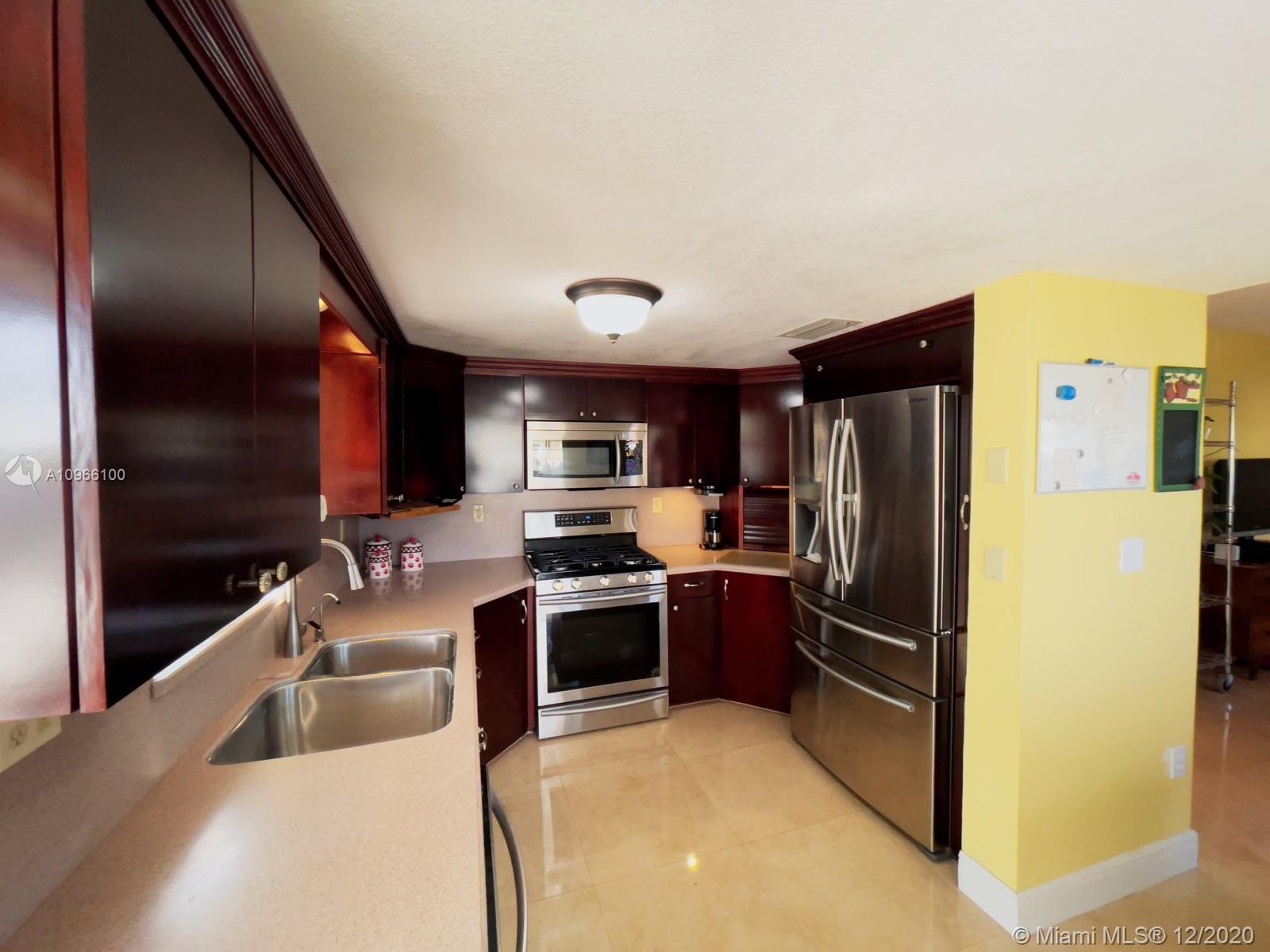 4753 Southwest 154th Court Miami, FL 33185 - Photo 7 of 27 The chef of the house will love this kitchen with custom cabinets and counters where every inch is utilized for storage, also you have a gas range and stove.
