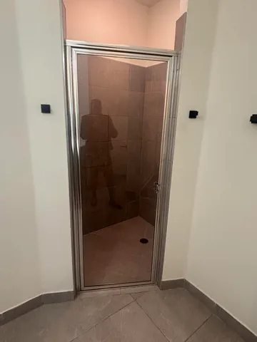 a bathroom with a glass shower door